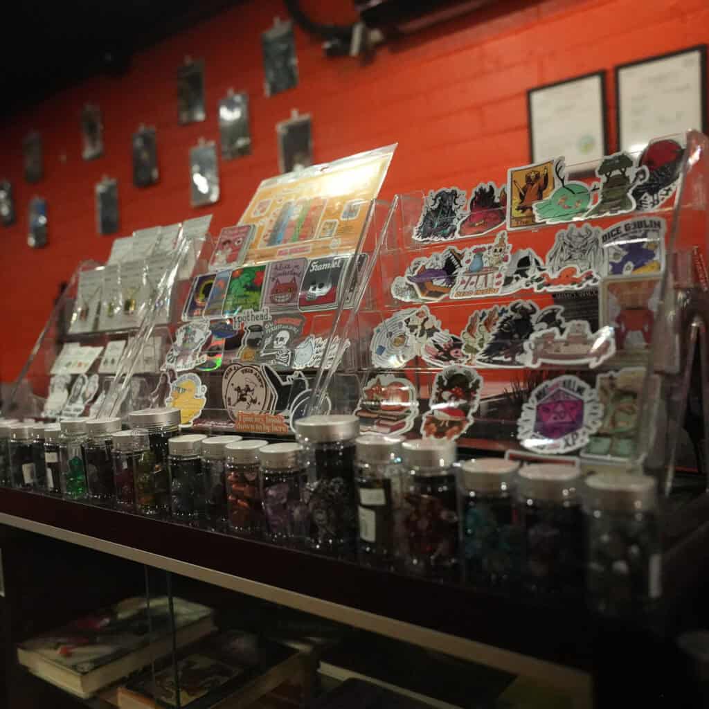 Display of stickers and collectibles at Cult Fiction Bookshop.