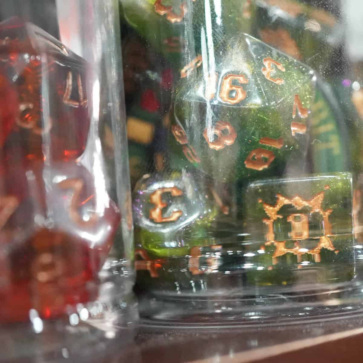 Close-up of colorful gaming dice in a display case at Cult Fiction Bookshop.